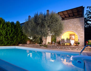 Vederi Estate Villa Kalypso pool, villa exterior and the olive tree at dusk