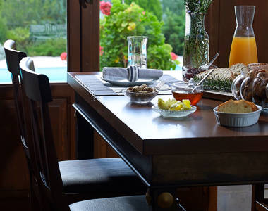 Vederi Estate Villa Alkioni kitchen chairs and table full with breakfast