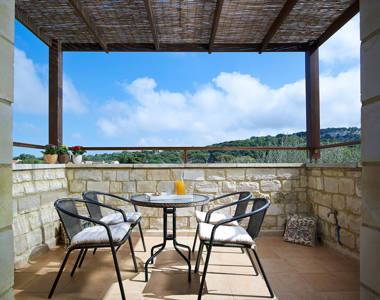 Vederi Estate Villa Kalypso balcony with small round table, chairs and balcony view