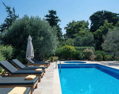Vederi Estate Villa Melpomeni sunbeds, pool and foliage