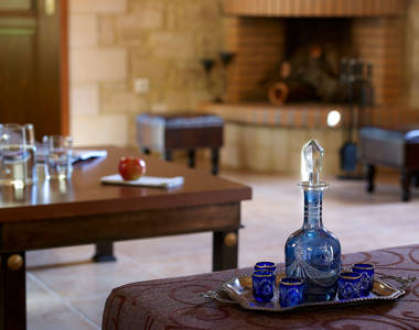 Vederi Estate Villa Kyveli living room amenities and the fireplace blurred in the background