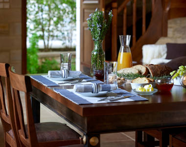Vederi Estate Villa Alkioni kitchen table prepared for breakfast