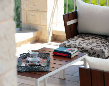 Vederi Estate Villa Melpomeni balcony table with a book and a tray with two teacups on it