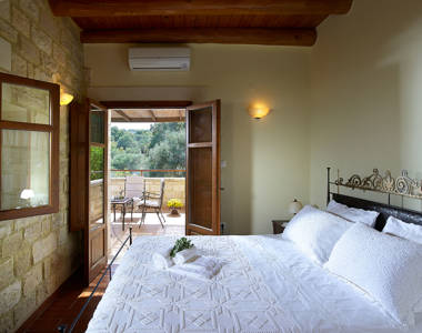 Vederi Estate Villa Kyveli bedroom with double bed, amenities and balcony view